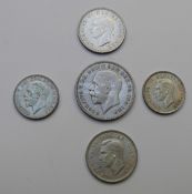 1935 George V 'rocking horse' crown, F+ together with a 1928 florin and three George VI coins,