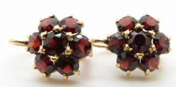 A pair of 18ct gold earrings set with clusters of garnets