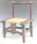 A carved child's chair with steel finials and 