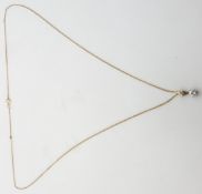 A white gold pendant set with a round cut diamond of approximately 0.2ct on 9ct gold chain