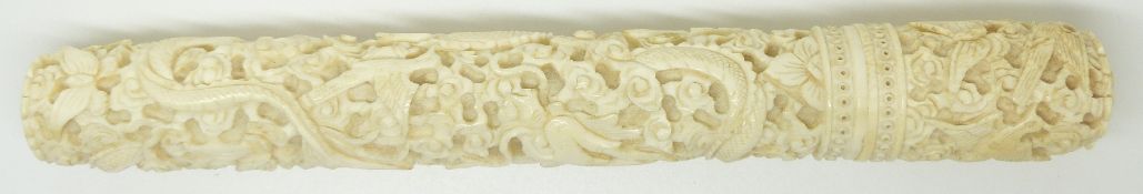 A 19thC Chinese ivory needle case deeply carved with dragons and birds, complete with needles,
