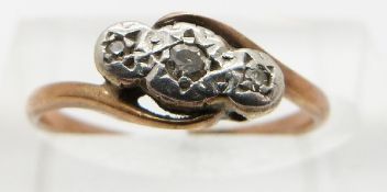 A yellow metal ring set with three diamonds in a platinum setting