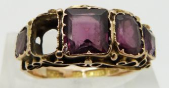 A 15ct gold ring set with garnets, Birmingham 1873, with engraved band, size M