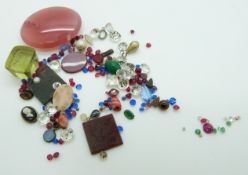 A collection of loose gemstones including a seal, agate, paste, rubies, emeralds, diamonds etc
