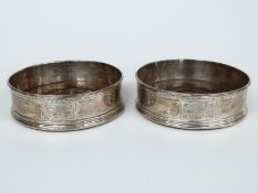 A pair of Georgian hallmarked silver wine coasters with bright cut decoration, London 1797 maker's