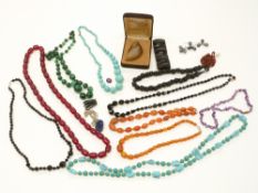 A collection of beaded necklaces including malachite, amber, agate, jet etc