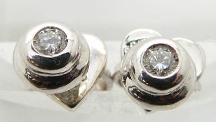 A pair of 18ct white gold studs set with a diamond to each