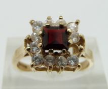 A 9ct gold ring set with a garnet, size O