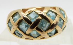 A yellow metal ring set with blue paste, size N