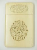 A 19thC Chinese ivory card case with carved cartouches of figures among buildings to both sides,