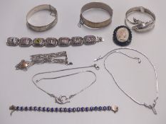Two silver bangles, another silver bangle in the form of a dophin, silver bracelet set with lapis
