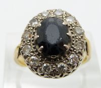 An 18ct gold ring set with an oval sapphire surrounded by round cut diamonds each approximately 0.