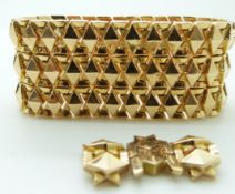 An 18ct gold bracelet made up of raised diamond shaped links, 63.4g