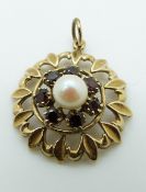 A 9ct gold pendant set with a pearl and garnets