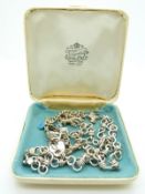 A silver charm bracelet and a silver necklace