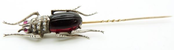 A Victorian stick pin in the form of an insect / beetle set with seed pearls and paste, 9.5cm long
