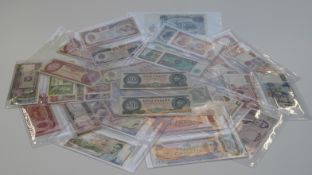 A collection of world banknotes from eight countries including Canada, India, Italy, Afghanistan,