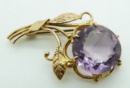 A 9ct gold brooch set with a large amethyst in the form of a bunch of flowers, 7g