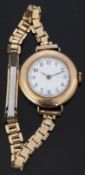 Swiss 9ct gold ladies wristwatch with Arabic numerals, gold hands, white enamel face and 15 jewel