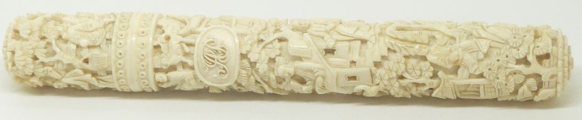 A Chinese ivory needle case deeply carved, with domestic scenes and monogrammed, complete with
