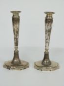 A pair of continental white metal candlesticks with octagonal bases, indistinct possibly German