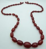A graduated cherry amber necklace made up of oval beads, 117g