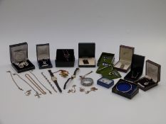 A collection of silver jewellery including a bracelet set with garnets, spoon, necklaces including