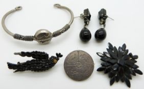 Two jet brooches, a pair of French jet earrings, Victorian love token and a bangle