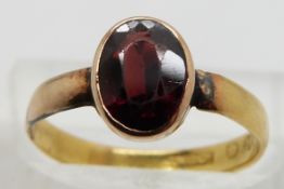 Victorian 22ct gold ring set with an oval cut garnet, size L