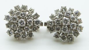 A pair of 18ct gold earrings each set with a large cluster of diamonds, totalling approximately