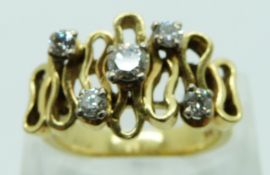 An 18ct gold ring set with five diamonds in an abstract design with textured band, the largest