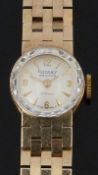 Rotary Maximus 9ct gold ladies wristwatch with gold hands and hour markers, cream dial, bevelled