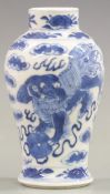 A 19thC Chinese small baluster vase decorated with two dogs of Fo and four character marks to