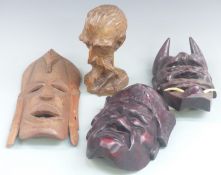 Three carved African masks and carved head, largest 32cm