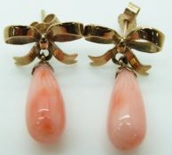 A pair of 9ct gold earring's in the form of bows with a pear drop coral bead to each
