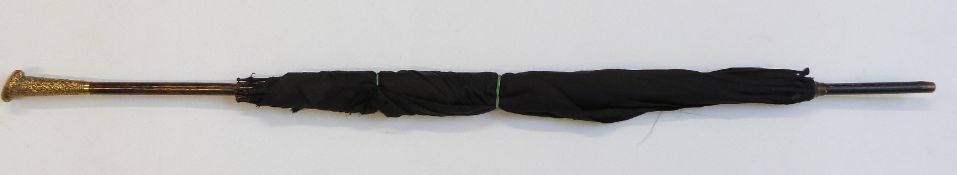 A late 19thC/20thC parasol with yellow metal handle in the form of a heart, with vacant cartouche