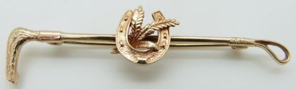 A 9ct gold brooch in the form of a crop and horseshoe, maker H.G & S