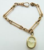 Victorian rose gold bracelet made up of elongated and knot links with a 9ct gold charm set with