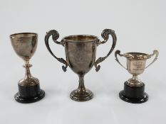 Three various hallmarked silver trophy cups, largest 12cm tall, 76g, other two attached to bases,