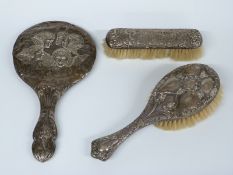 Hallmarked silver mounted Reynold's Angels hand mirror and brush and a further silver mounted brush