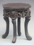 A Chinese carved hardwood stand in the form of a Padauk table, height 25 x diameter 21 cm