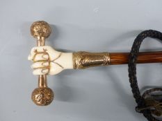 Victorian parasol, the handle an 18ct gold plated and ivory fist holding a bar, with yellow metal