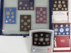 Royal Mint deluxe cased brilliant uncirculated millennium 2000 coin set together with a 1999 and