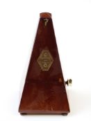 French metronome in mahogany case raised on bun feet