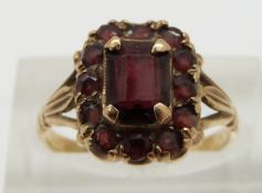A 9ct gold ring set with garnets, size N