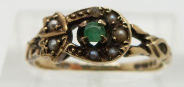 A 9ct gold ring set with an emerald and seed pearls