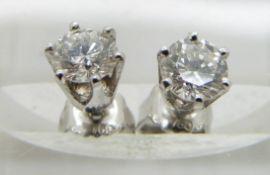 A pair of 18ct white gold earrings set with a diamond of approximately 0.4ct to each
