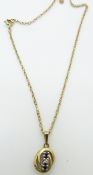 A 9ct gold necklace and pendant set with two sapphires and a diamond, 2.7g