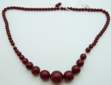 A graduated cherry amber necklace made up of round beads, 47g