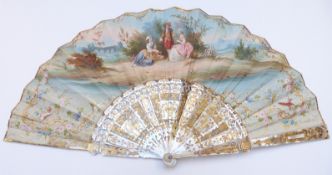 A mother of pearl fan with pierced and gilt decoration and painted scenes, in original velvet